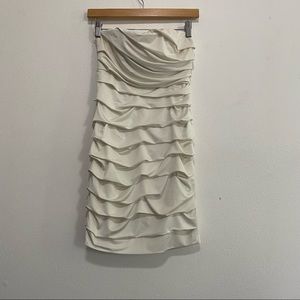 A cream colored ruched strapless dress